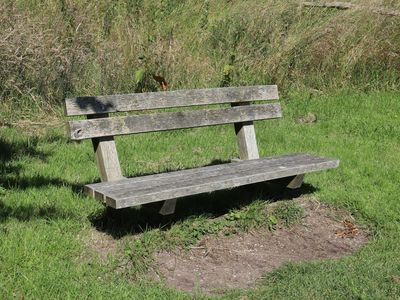 A bottle of water on a bench in a gym